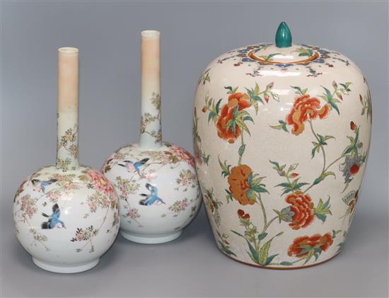 A Japanese crackleware lidded jar and a pair of Japanese vases tallest 32cm